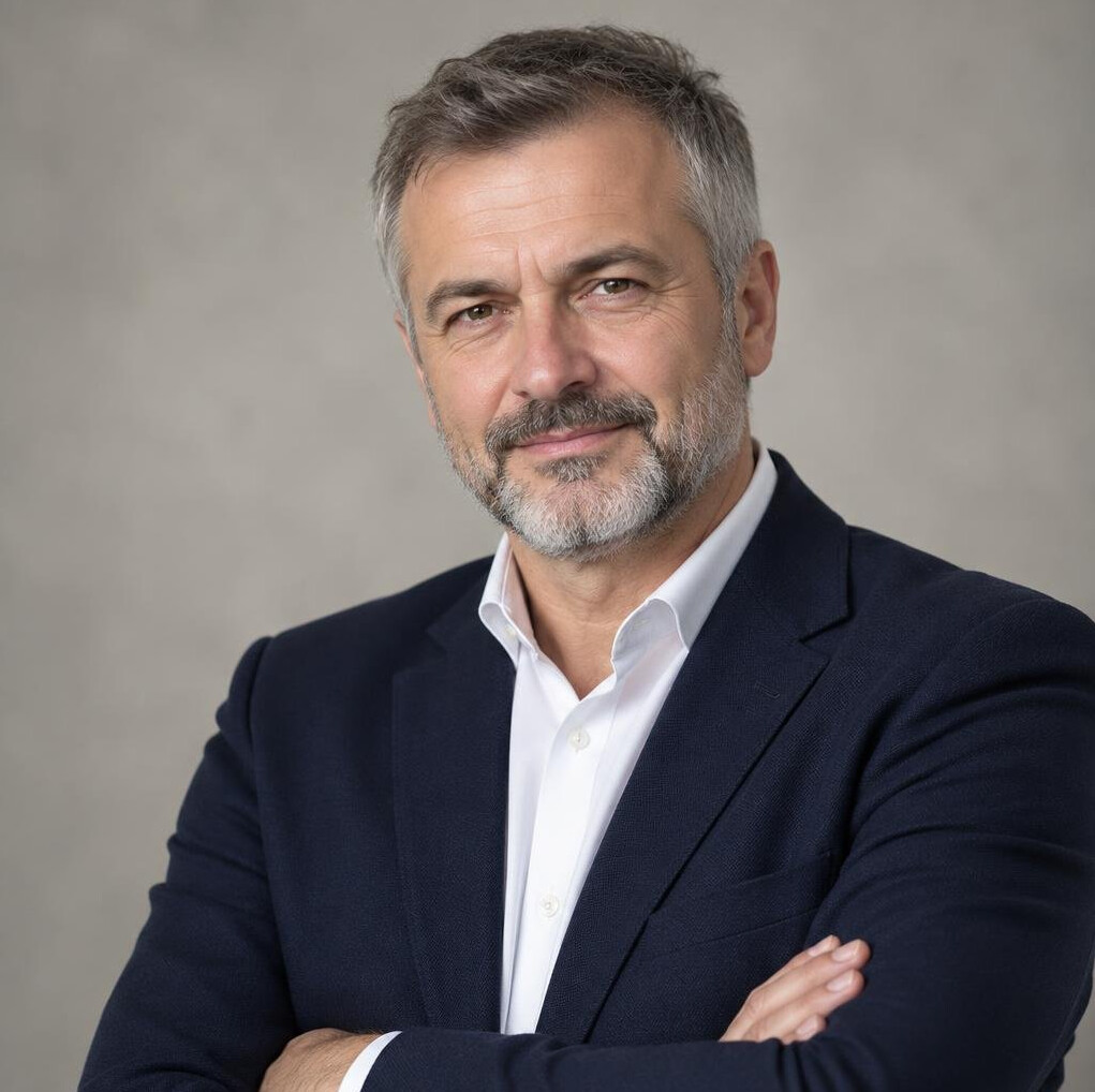 Studio portrait of a Croatian male author in his fifties wearing a dark blazer